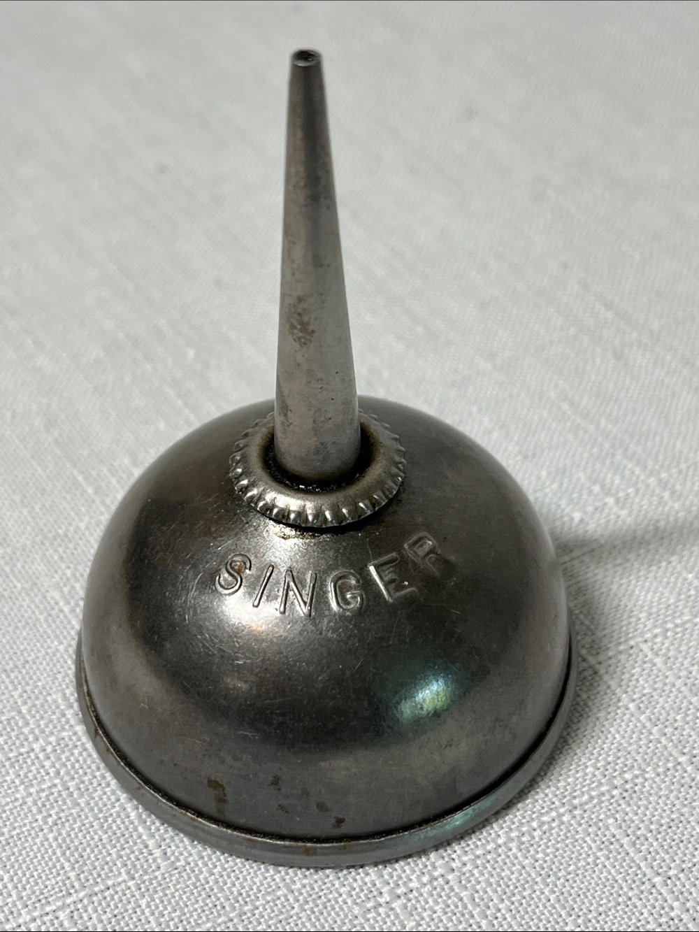 Vintage Singer sewing machine oil can, a thumb pump oiler.
embossed "SINGER"